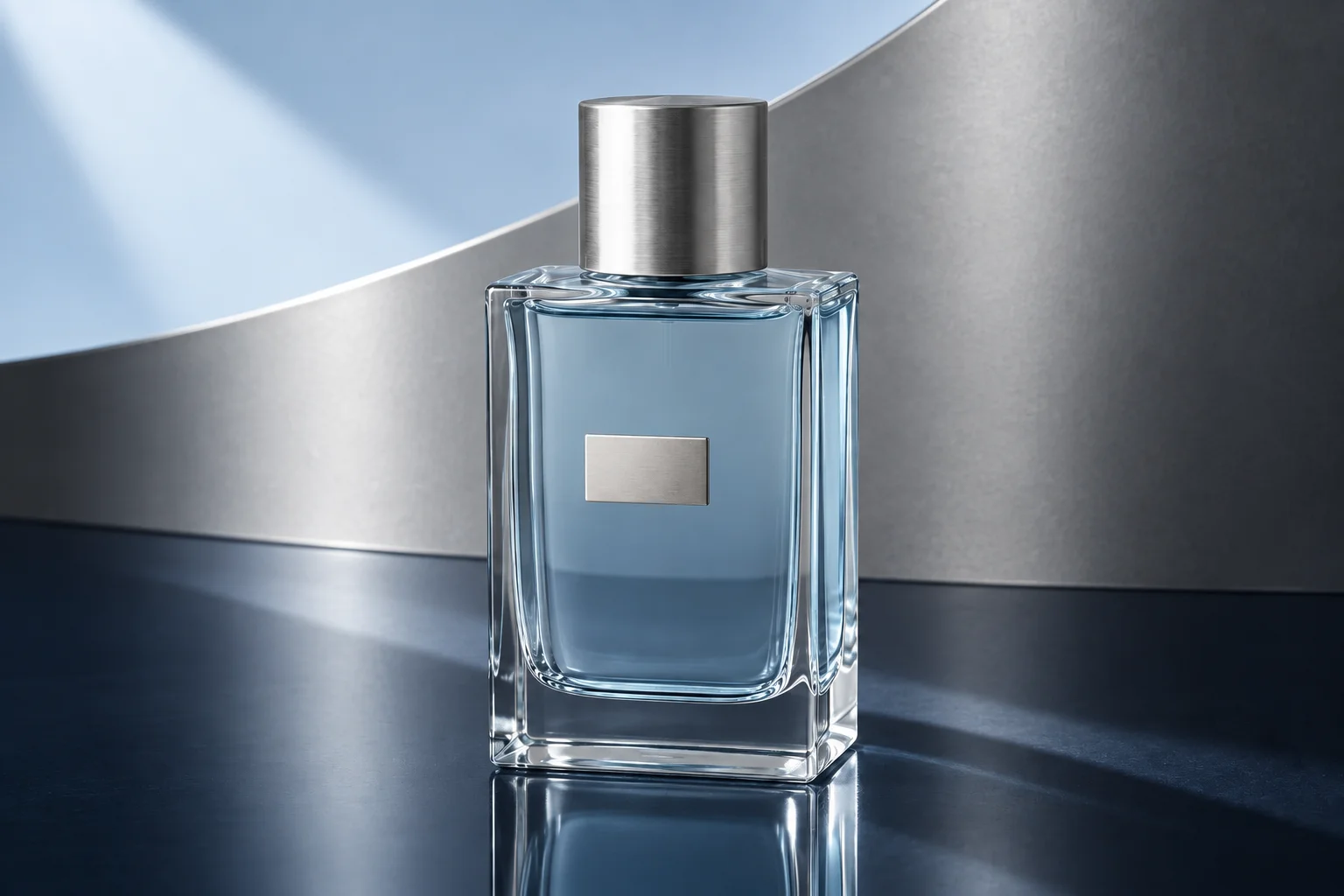 A clear perfume bottle in a silver architectural studio with controlled blue reflections